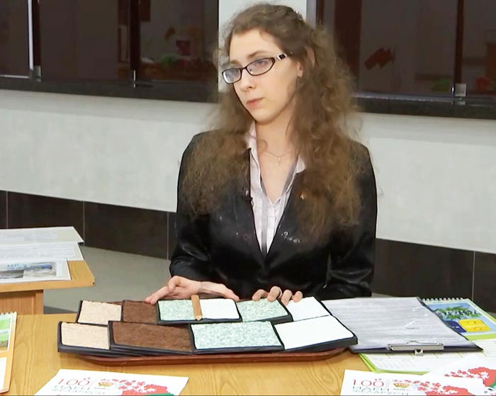 Елена Сапронова показывает образцы с авторскими жидкими обоями